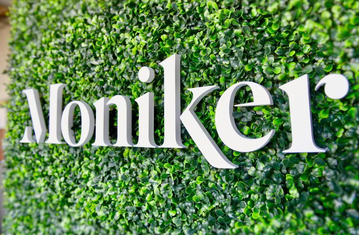 Branded greenery wall photo booth backdrop